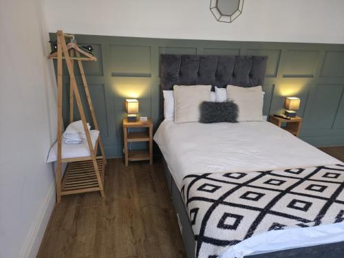 a bedroom with a bed and a ladder and two lamps at West Beck House Newcastle - Spacious Double Room in North Shields