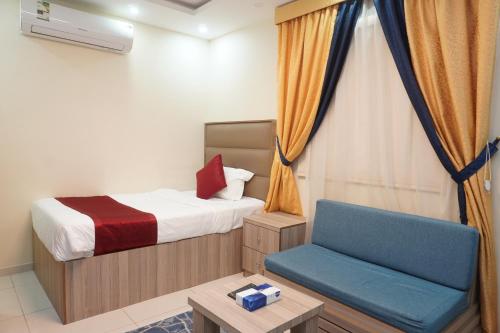 a small bedroom with a bed and a chair at Dyar Sultana - 10 Mins Drive to Al Masjed Al Nabwi in Sulţānah