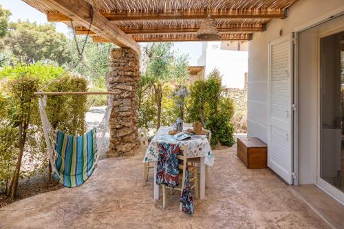 a table and chairs on the patio of a house at Cava Li Santi Residence a Santa Caterina in Nardò