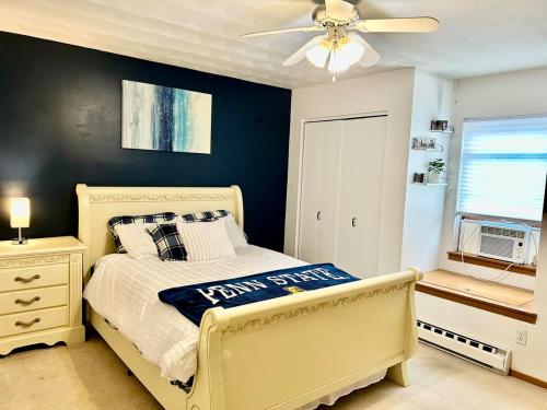 a bedroom with a bed and a ceiling fan at Alumni Corner in State College