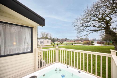 a balcony with a hot tub on a house at The Major Oak Lodge with Hot Tub in York
