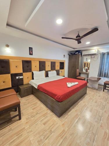 a bedroom with a large bed with a red blanket at Bluebell castle in Mahabalipuram