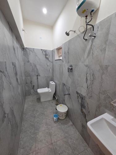 a bathroom with a toilet and a sink at Bluebell castle in Mahabalipuram