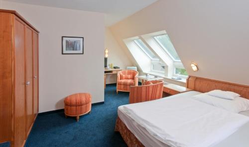 Postel nebo postele na pokoji v ubytování Ringhotel Fährhaus
