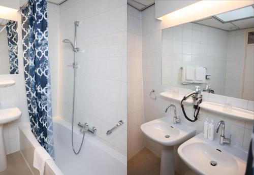 a white bathroom with a sink and a shower at Hotel Noordzee in Katwijk aan Zee