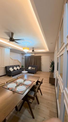 a living room with a table and a couch at Hm home 2 in Sepang