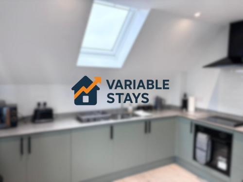 a kitchen with a variable stays sign on the counter at Castle-View Apartment & Free Parking on Site in Dover