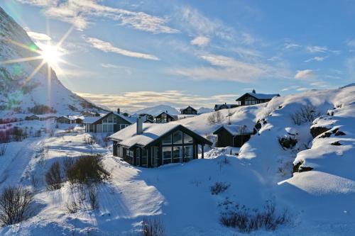a winter view of a lodge in the snow at Lofoten Links Lodges in Gimsøy