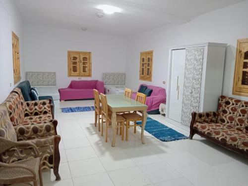 a living room with a table and chairs at Marwan Farmhouse Rooftop Apartment in Faraj Māḑī