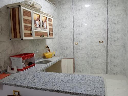 a kitchen with a sink and a counter top at Marwan Farmhouse Rooftop Apartment in Faraj Māḑī