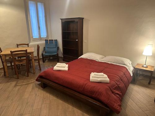 a bedroom with a bed with two towels on it at Suite Cerchio 3 - City Center in Ravenna