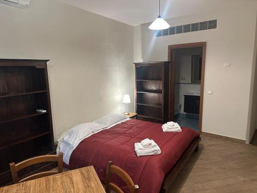 a bedroom with a bed with two towels on it at Suite Cerchio 3 - City Center in Ravenna