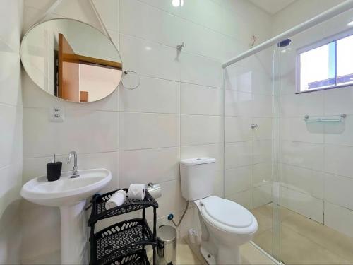 a bathroom with a toilet and a sink and a mirror at 3 Frontiers Landmark House in Foz do Iguaçu