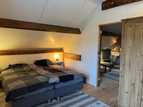 a bedroom with a large bed in a room at Relaxed Guesthouse in Heibloem