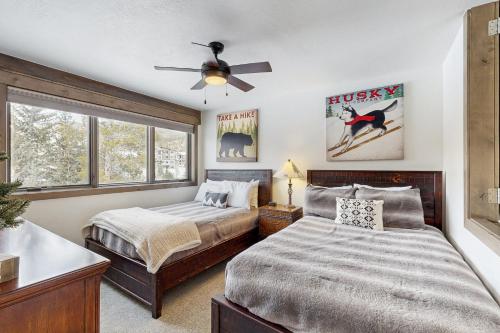 a bedroom with two beds and a ceiling fan at The Pines Condo Unit 2044 in Keystone