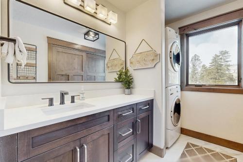 a bathroom with a sink and a washer and dryer at The Pines Condo Unit 2044 in Keystone