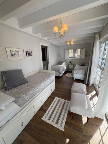 a bedroom with two beds and a living room at La Casa de Nueva in Nueva de Llanes