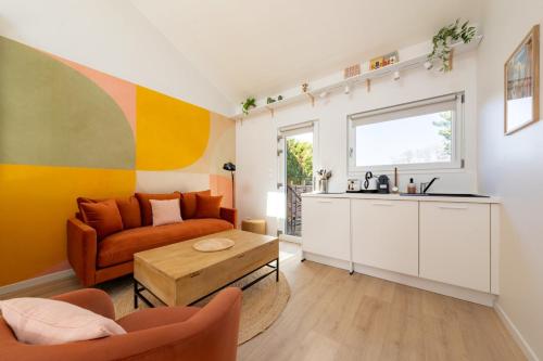 a living room with a couch and a table at Air Nomad • Séville in Valenciennes