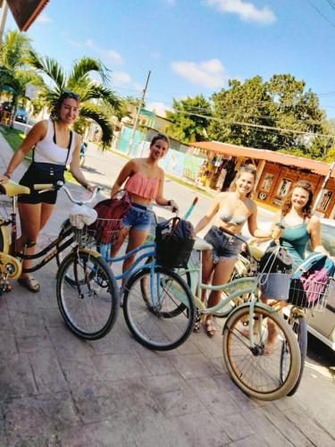 a group of women standing next to their bikes at Estudios Bacalar in Bacalar