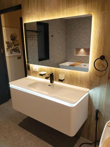 a bathroom with a white sink and a mirror at Luxury Villa by Andres in San Juan