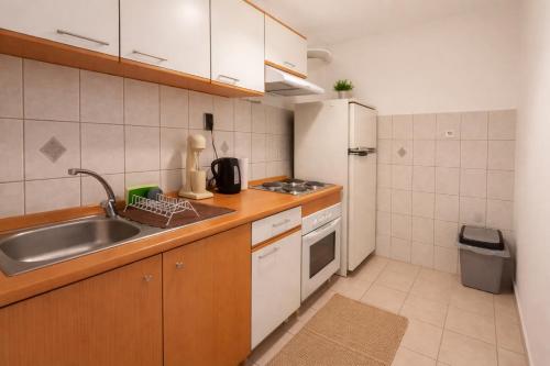 a small kitchen with a sink and a refrigerator at Sampa Villa in Asprovalta