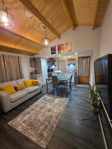 a living room with a couch and a table at Secluded Log Cabin escape in High Wycombe