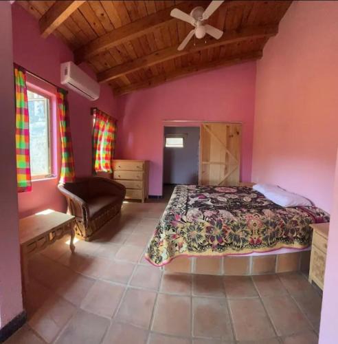a bedroom with a bed and a ceiling fan at Las Casitas de La Bahia Calechosa in Emiliano Zapata