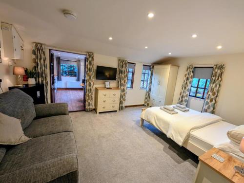 a living room with a bed and a couch at The Garden Lodge in Llynclys