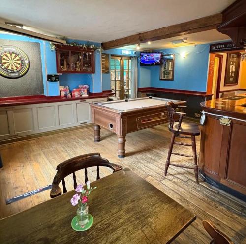 a room with a pool table and a bar at The Jolly Brewers in Bishops Stortford