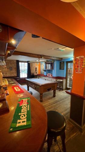a room with a pool table and a ping pong table at The Jolly Brewers in Bishops Stortford