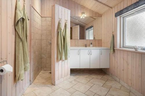 a bathroom with a shower and a sink and a door at M402-Vaeggerlose-Stolt-Henriksvej-93 in Bøtø By