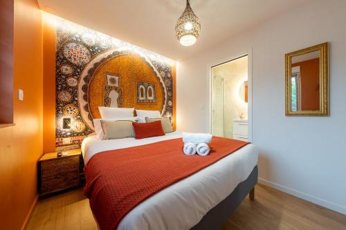 a bedroom with a large bed with two towels on it at Air Nomad • Marrakech in Valenciennes