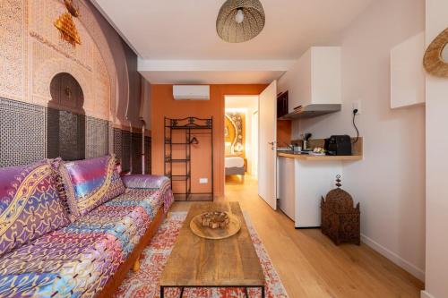 a living room with a couch and a table at Air Nomad • Marrakech in Valenciennes