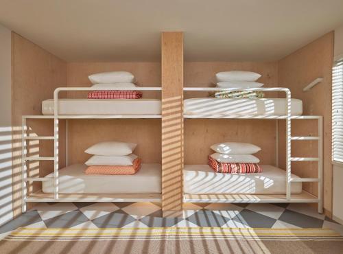 a room with white shelves with dishes on them at The Asbury Hotel in Asbury Park