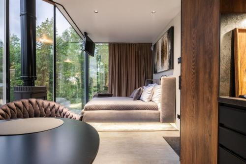 a bedroom with a bed and a large window at Luxury Resort Orava in Orava