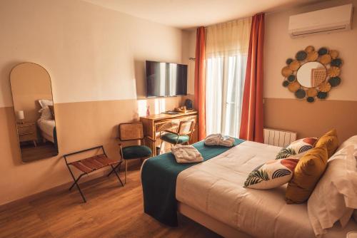 a hotel room with a bed and a mirror at Golf Resort de Digne-les-Bains by Adonis in Digne-les-Bains