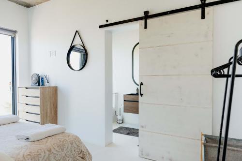 a bedroom with a sliding barn door at Beyond The Beach in Yzerfontein