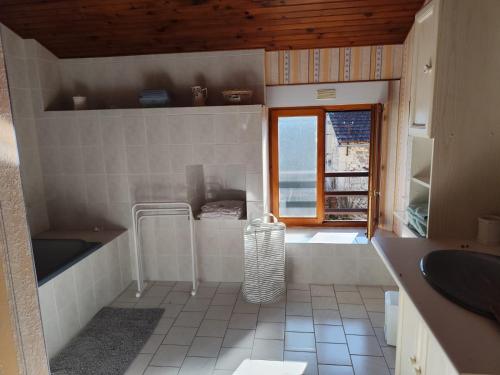 a bathroom with a sink and a window at Dépaysement à la campagne in Saint-Martin-de-Sanzay
