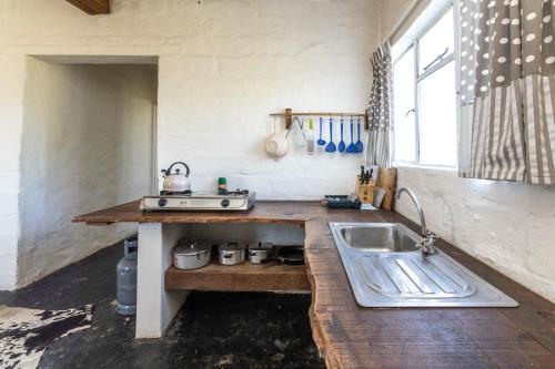 a kitchen with a sink and a counter top at Lumberjack Cottage at Blombosch Game Farm in Yzerfontein