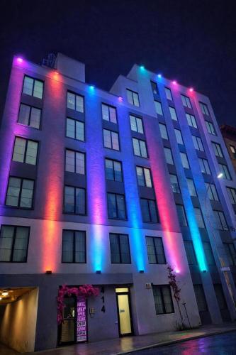 a building with purple and blue lights on it at Rose Hotel Near Yankee Stadium in Bronx
