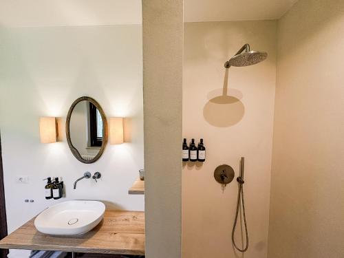 a bathroom with a sink and a toilet and a mirror at Agriturismo Scala - Eco Boutique B&B in Le Marche in Potenza Picena
