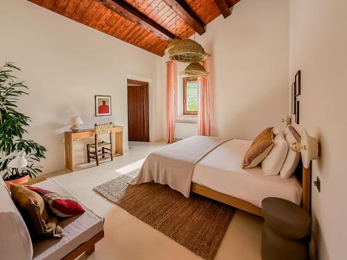 a bedroom with a bed and a chair in it at Agriturismo Scala - Eco Boutique B&B in Le Marche in Potenza Picena