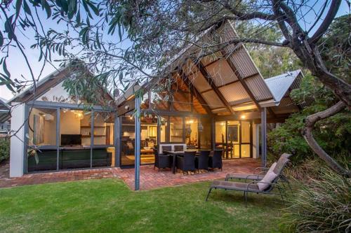 a house with a living room and a backyard at Whalers Cove Villas in Dunsborough