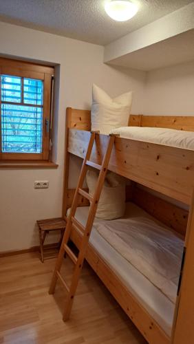a bunk bed with a ladder in a room at Appartment Shelley in Vandans