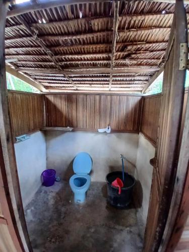 a bathroom with a blue toilet in a stall at Saubaryam Home stay in Fam