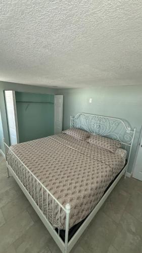 a bed in a bedroom with a bed frame at Modern 3BR Home in secure neighborhood with Free Parking & WiFi in Riverview