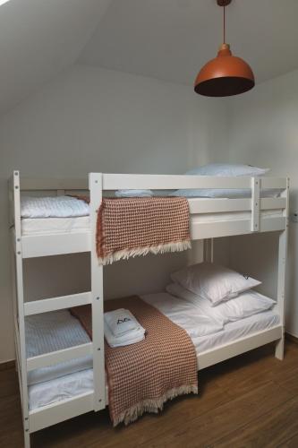 a bedroom with two bunk beds and a lamp at VILLA nad JEZIOREM in Mucharz