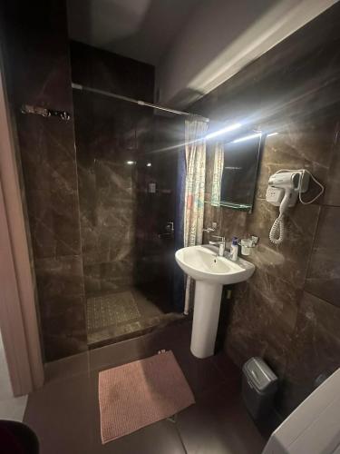 a small bathroom with a sink and a shower at Bakuriani apartment in Bakuriani