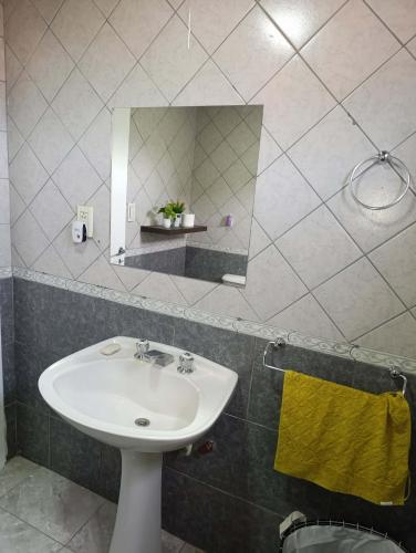 a bathroom with a sink and a mirror at Casa Ruta 3 Río Gallegos in Río Gallegos