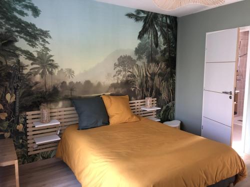 a bedroom with a bed with a painting on the wall at Dom & Val in Tournan-en-Brie